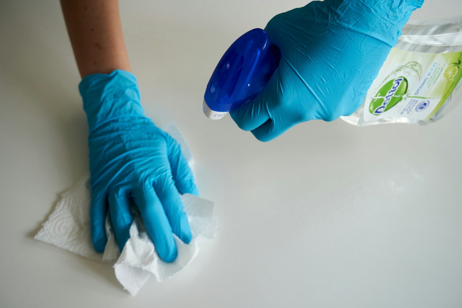 A cleaner carefully wiping a surface